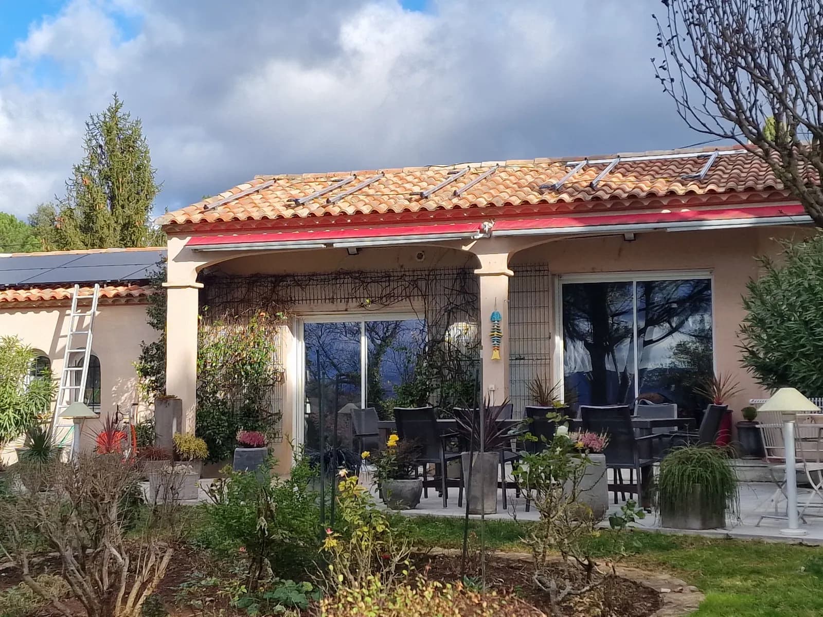 Rails de fixation posés sur la toiture d’une villa, panneaux déjà installés sur l’annexe