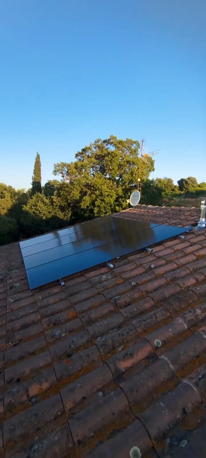 Huit panneaux photovoltaïques sur tuiles anciennes, chêne et parabole